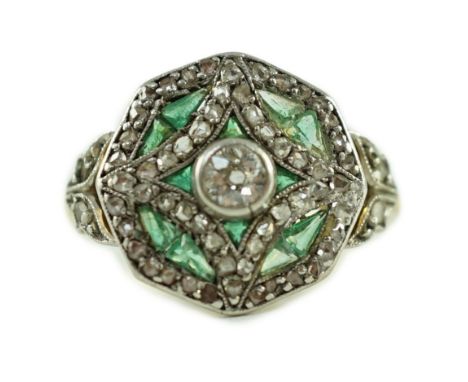 A Belle Epoque gold, emerald and diamond cluster set octagonal dress ring, size M, gross 4 grams.Two of the small emerald eac