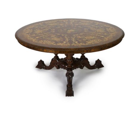 A Victorian walnut and marquetry breakfast table, of unusually large proportions, the circular top with foliate carved edge, 