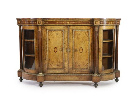 A Victorian walnut and marquetry side cabinet, with central twin panelled doors and bowed glazed doors separated by fluted co