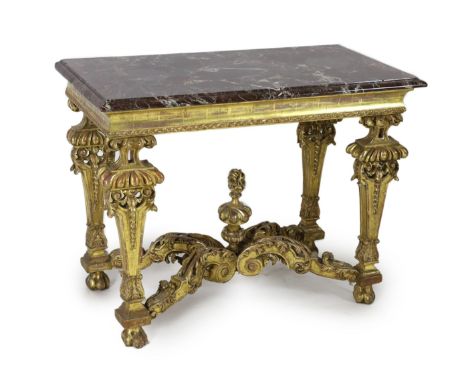 A Louis XIV period carved giltwood console table, with variegated rouge marble top, concave frieze and ornate foliate carved 