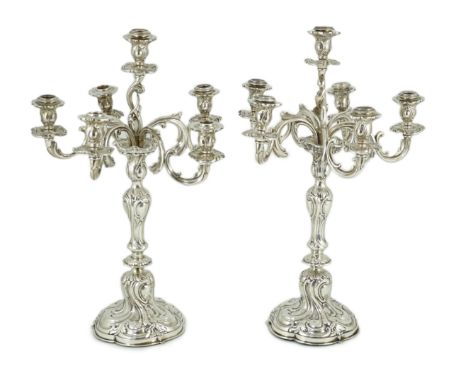 A pair of late 19th century German 800 standard white metal Rococo style, five branch, six light candelabra, by Vollgold, wit