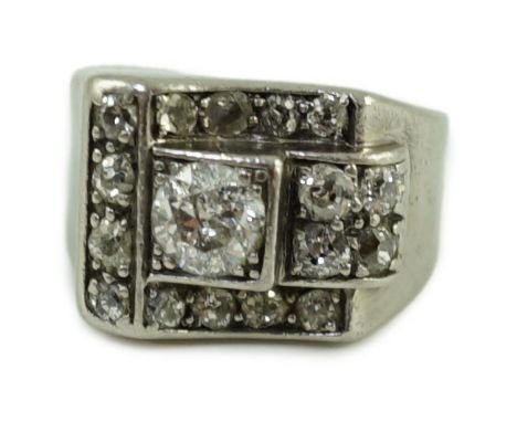 An Art Deco platinum? and diamond cluster set dress ring, the central stone weighing approximately 0.45-0.50ct, size E, gross