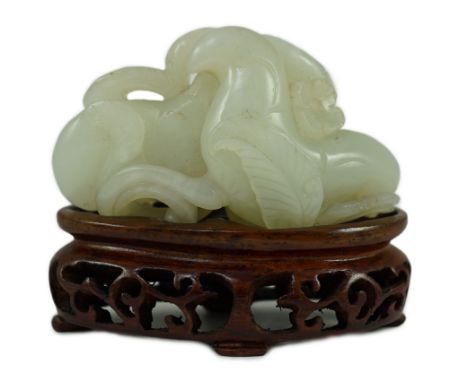 A Chinese pale celadon jade ‘Lotus’ pebble carving, 18th/19th century, the stone of good even tone with some occasional paler