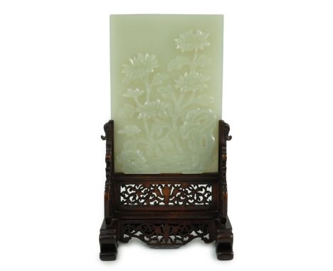 A good Chinese celadon jade ‘peonies and rockwork’ small table screen and stand, 18th/19th century, carved in high relief to 