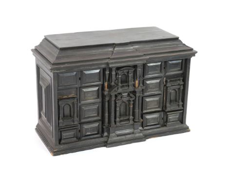 An early 18th century Portuguese ebonised table cabinet, of architectural form, with central door enclosing an ornately inlai