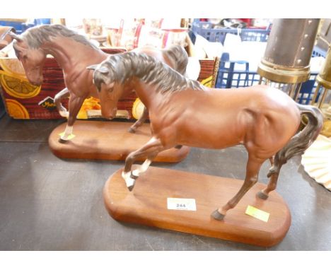 Two Beswick horses on wooden plinths