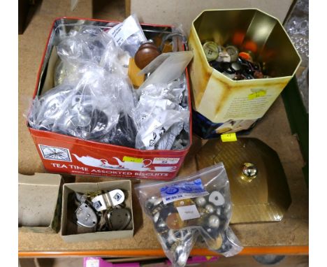 Two boxes of castors, buttons, door furniture etc