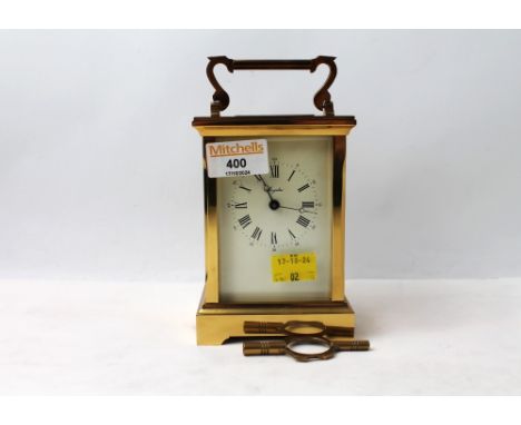 Brass cased carriage clock with key, faceted glass panels 