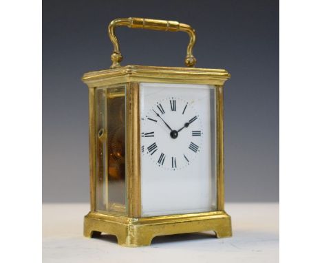 Early 20th Century brass carriage clock, the white enamel dial with Roman numerals, carry case   Condition: 