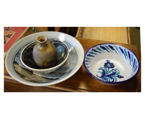 Four items of pottery to include; a Highland Stoneware bowl with coastal scene, stoneware vase in the St Ives/Leach tradition