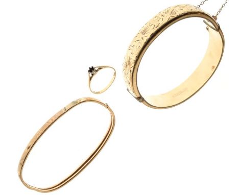 Snap bangle having engraved decoration, marked 9ct metal core, one other bangle marked 9ct and a 9ct unmounted gold ring, 5.3