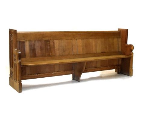 Late 19th/early 20th Century carved oak pew of double-ended design with lancet arch panels to sides, solid seat and two rear 