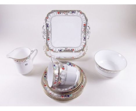 An Art Deco Shelley tea service comprising: twelve cups and saucers, twelve tea plates, milk and sugar and two sandwich plate