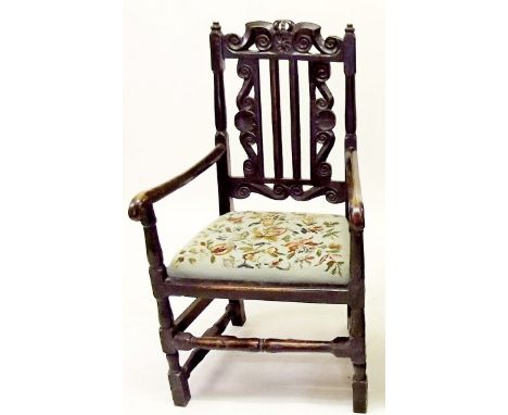 A Victorian side chair in the Jacobean manner with ornately carved back and tapestry seat
