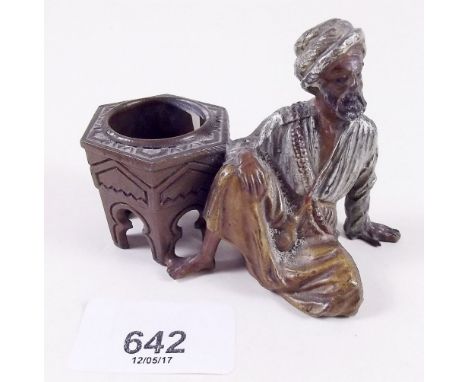 A small inkwell modelled as a seated Arab