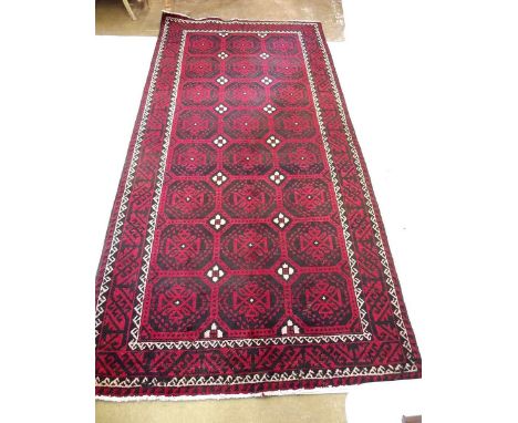 A Persian Hammadan Lori carpet with all over design in red and black - 303 x 145cm