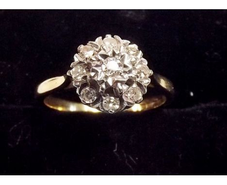 An 18ct gold diamond cluster ring , size K