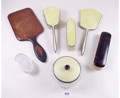 A yellow enamel four piece dressing table set and wooden hand mirror