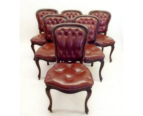 A set of six Victorian mahogany balloon back dining chairs with button upholstered  leatherette seats and backs