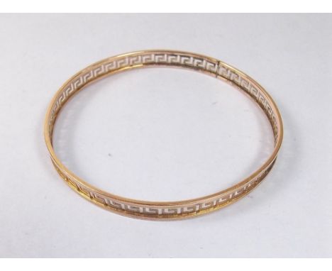 A 9 carat gold bangle decorated in the Greek key pattern, 9.5g
