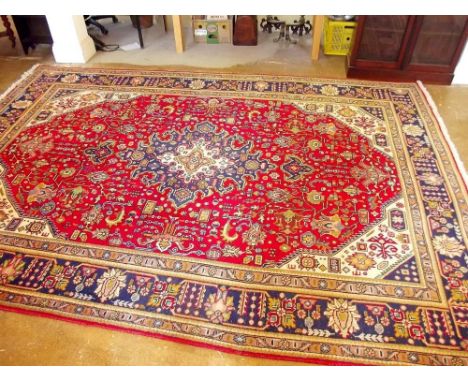 A large red Persian Tabriz style medallion design carpet - 350 x 240cm