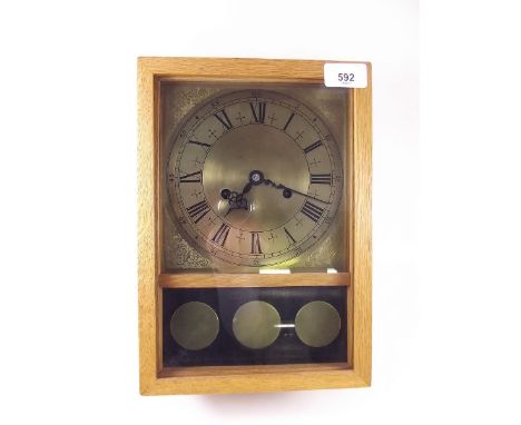 An oak chiming mantel clock
