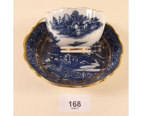 An 18th century Caughley tea bowl and saucer printed in the Two Men on a Bridge pattern, S mark to base, wear to gilding on r