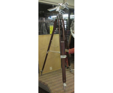 GERMAN WWII FIELD SPOTTERS BINOCULARS, polished metal and fully articulating on teak tripod base.