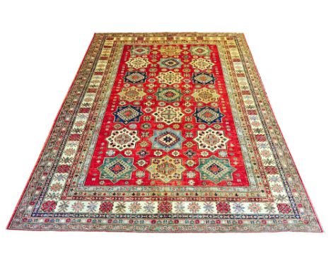 VERY FINE 'SUPER' KAZAK CARPET, 326cm x 236cm, repeat geometric star medallions on a ruby field within corresponding bands an