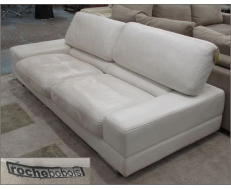 SOFA BY ROCHE BOBOIS, two seater, in an ivory leather with articulated back, 240cm x 104cm x 84cm.