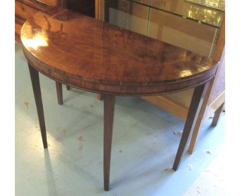 CONSOLE TABLES, a pair, Regency and later rosewood, tulipwood crossbanded demi lune each with beed moulded frieze on later su