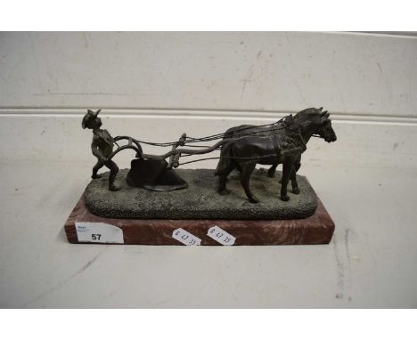 BRONZED METAL MODEL OF A PLOUGHMAN WITH TWO HORSES RAISED ON A MARBLE PLINTH BASE