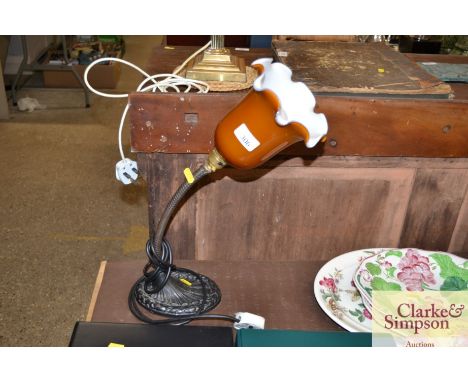 A 1930's lamp with opaque glass shade and cast iron base 