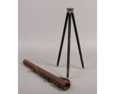 An early 20th century photographic tripod in leather case.