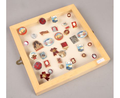 A collection case and loose quantity of mainly enamel pin badges for Russia and the USSR in Lenin.