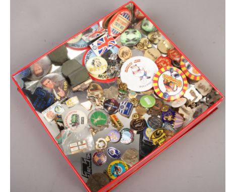 A tin of various enamel lapel badges etc.