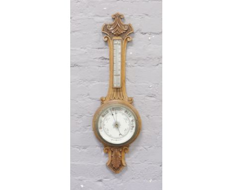 A carved oak banjo Android barometer.