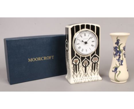 A boxed Moorcroft quartz mantel clock along with a Moorcroft vase decorated with bluebells.