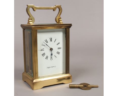 A brass cased carriage clock with white enamel dial 8 day movement by Mappin and Webb Ltd complete with key, 15cm height.Cond