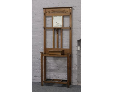 An early to mid 20th century oak hall stand with mirror, glove box and umbrella / stick stand.Condition report intended as a 