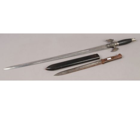 A decorative fantasy themed sword along with bayonet in wooden scabbard.