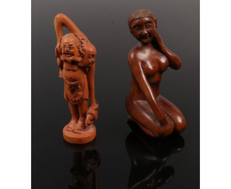 Two carved fruit wood netsuke one formed as a naked female figure and a similar example.