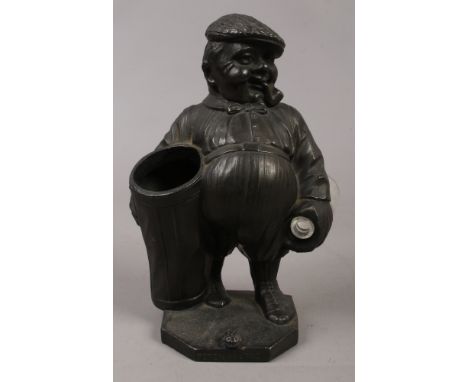 An early 20th century novelty Spelter spill holder formed as a golfing caddy Peter Putter.