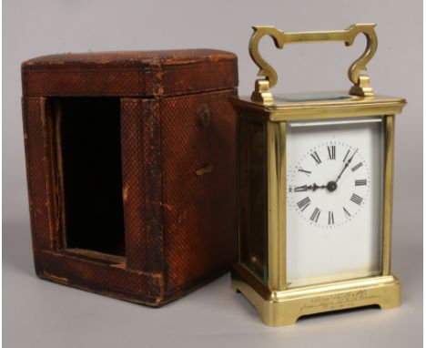 A brass cased carriage clock with 8 day movement white enamel dial in fitted leather case with key.Condition report intended 