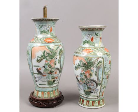 A pair of Chinese famille vert baluster vases, painted with figures in the landscape, both converted to lamp bases.