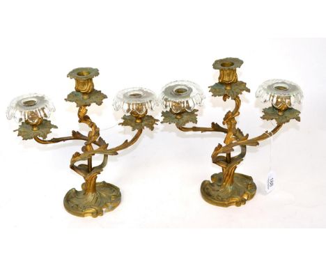 A pair of ormolu three light candelabra of rococo design, one stamped ''384B'' to underside 