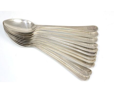 A set of eleven silver dessert spoons, George Howson, Sheffield 1906, engraved with twin crests and the motto scroll ''Labore