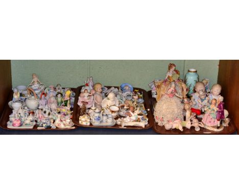 A large quantity of china half dolls, bisque figures, miniature tea wares etc (one shelf)