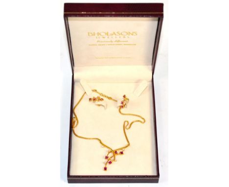 An Asian synthetic ruby and white paste necklace and earring suite, formed of crossover bars set with square cut synthetic ru