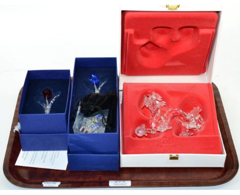 A Swarovski crystal model of a dragon, boxed; and two flowers